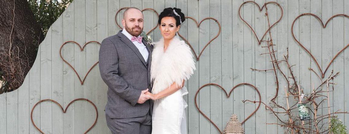 Naomi and Jamal hold each other at The Ashbourne Hotel, Killingholme near Grimsby on their wedding day by Gary Stafford Photography.