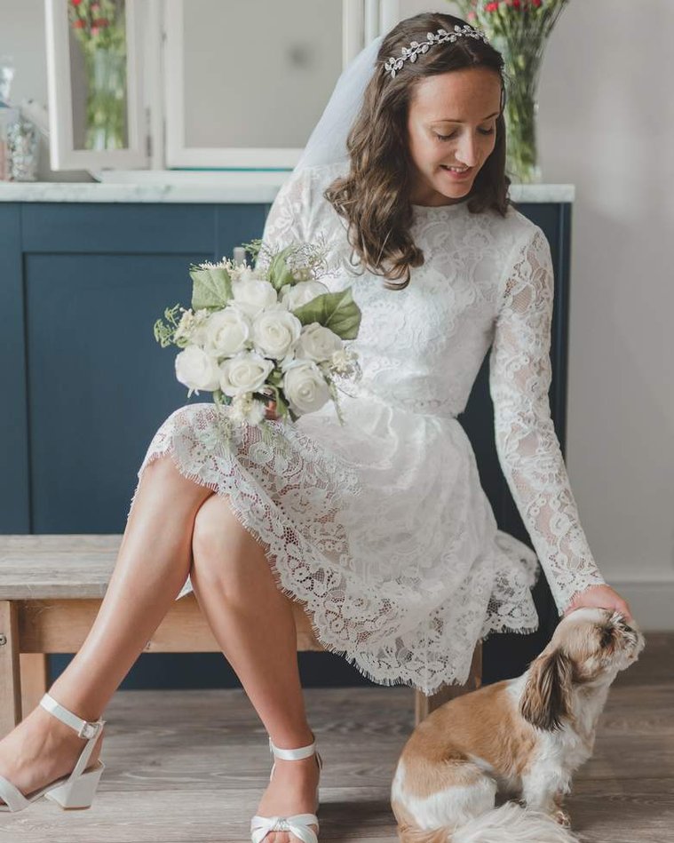 Shannon strokes her dog during her bridal shoot at her home in Grimsby on her wedding day by Gary Stafford Photography