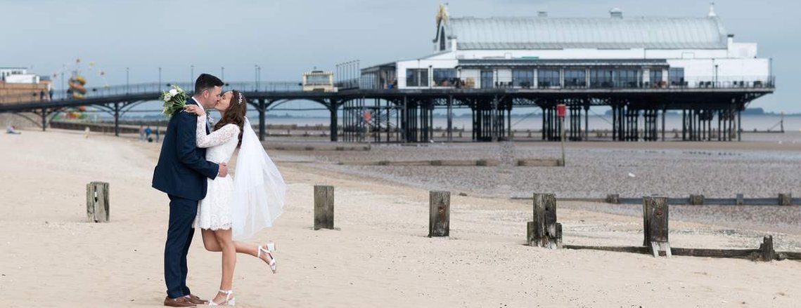 Shannon and Sam share a kiss in front of Cleethorpes Pier. by Gary Stafford Photography