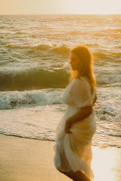 Senior portraits at Victoria Beach in Laguna Beach, CA. A warm, golden hue envelops the senior as she dances through the waves. Natural light, organic, romantic, dreamy wedding, engagement, elopement, photography by Aly Rose Photo. California photographer