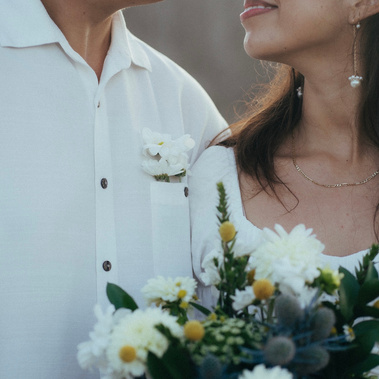 Two young lovers in white with wildflowers stare into each others eyes. Engagement photography in Costa Mesa, Orange County, CA, by Aly Rose Photo, wedding, engagement, elopement, portrait photographer in SoCal. 