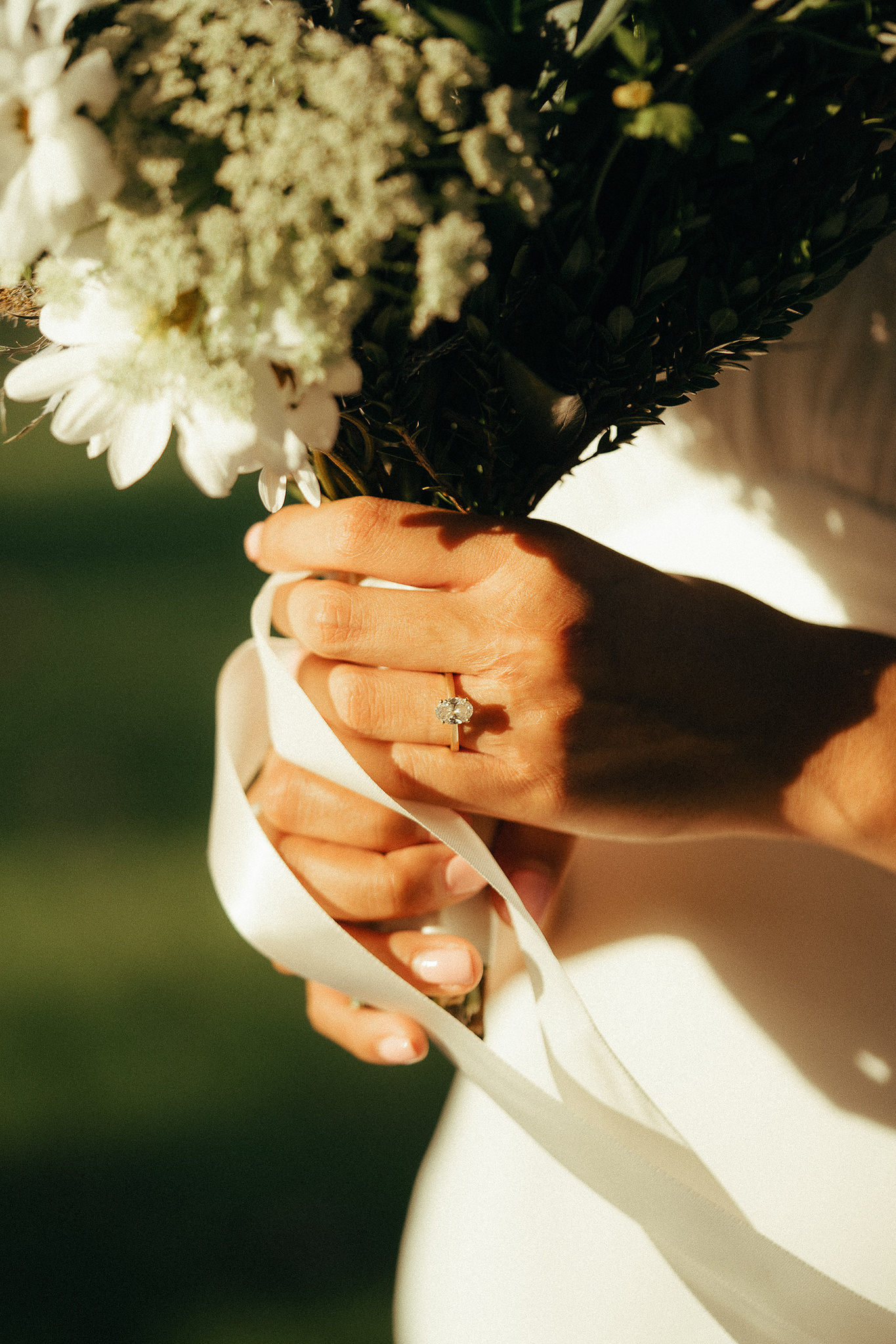 A close-up shot of the bride's diamond ring in the afternoon sun for two young lovebird's engagement photo session in Fairview Park, Costa Mesa, CA. Engagement photography by Aly Rose Photo. California wedding photographer