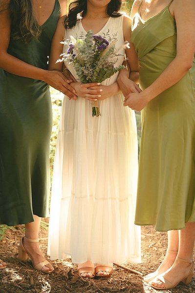The bride and her bridesmaids pose with a golden hue illuminating them from behind at an elopement ceremony in the Redwoods Grove, Orange County, CA. Natural light, organic, romantic, dreamy wedding, engagement, elopement, photography by Aly Rose Photo. 