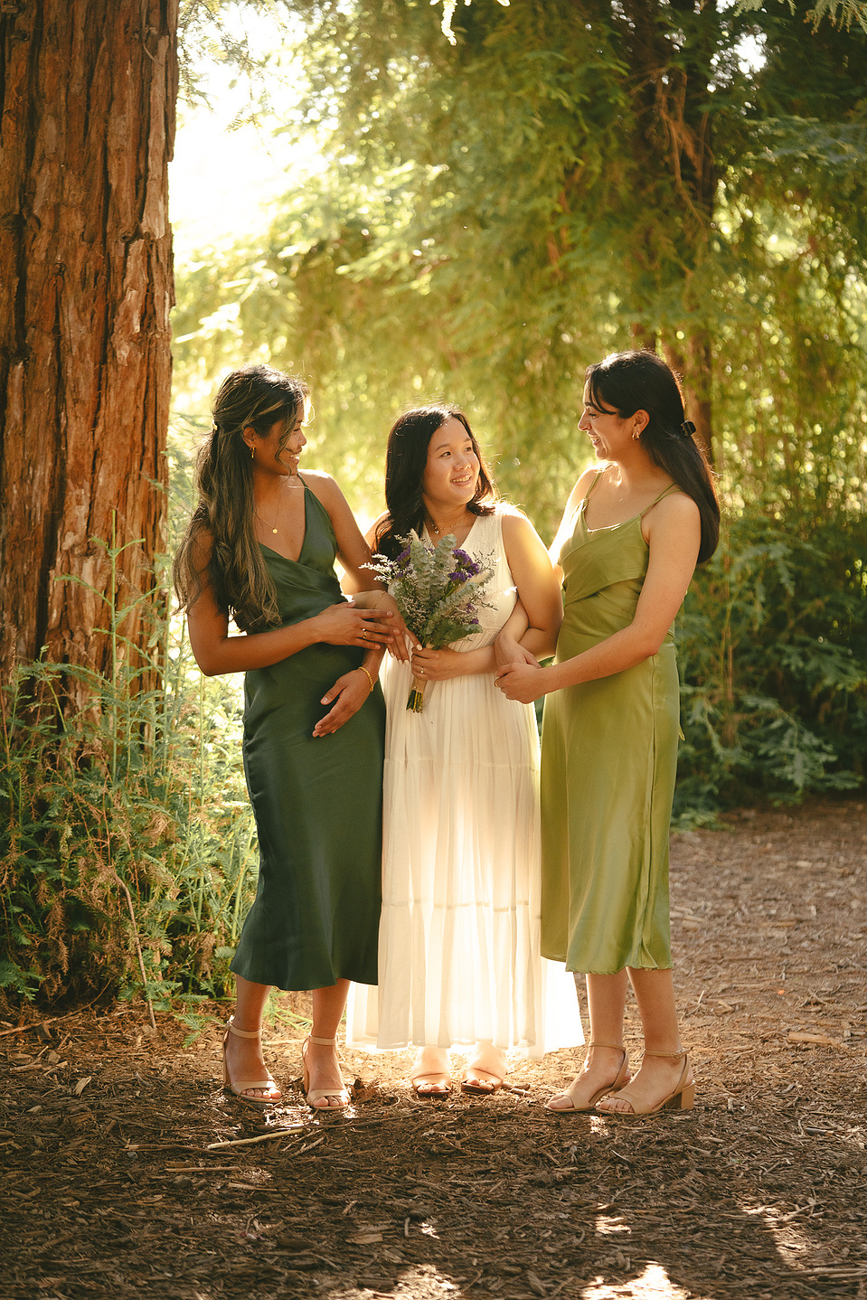 The bride and her bridesmaids pose for a warm, organic portrait. An intimate, romantic elopement in the Redwoods Grove in Orange County, CA. Aly Rose Photo, wedding, elopement, engagement, portrait photographer in Southern California.