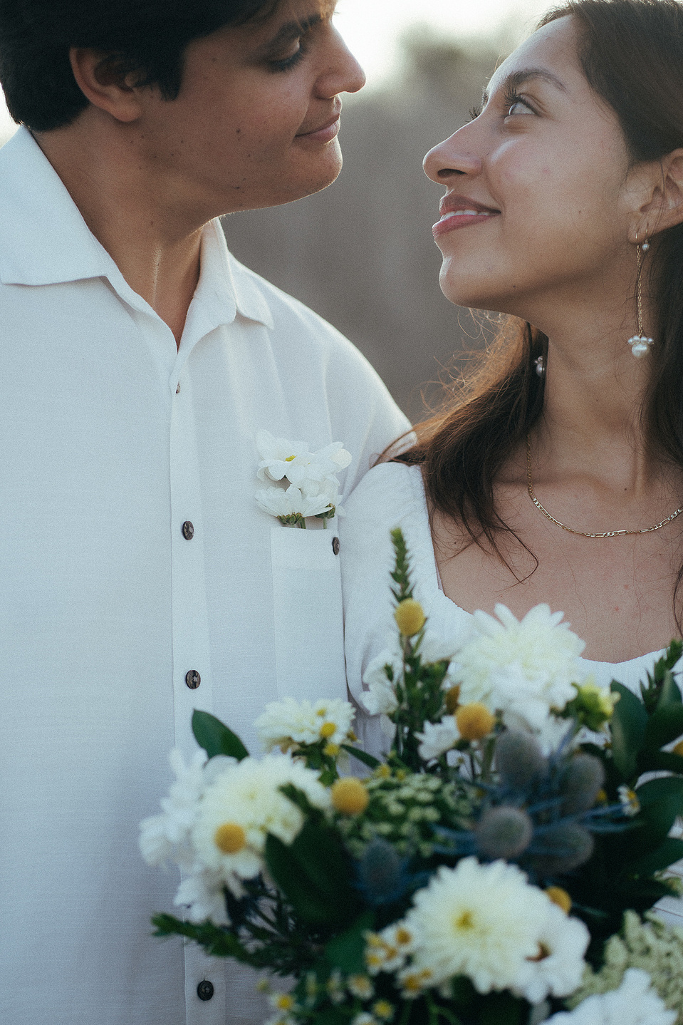 Two young lovebirds pose staring deep into each other's eyes at golden hour for their engagement photo session in Fairview Park, Costa Mesa, CA. Natural light engagement photography by Aly Rose Photo. California wedding photographer