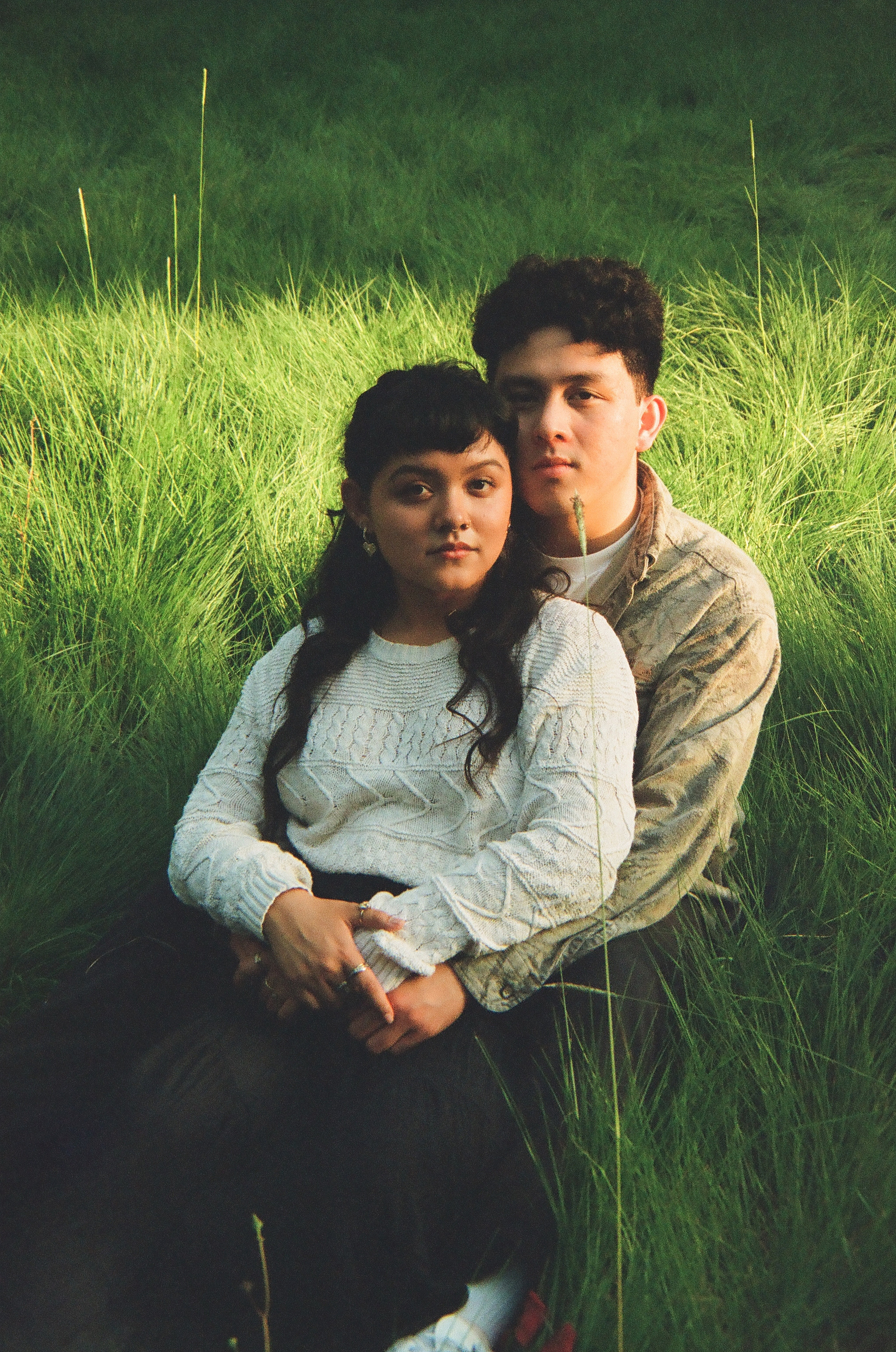 Two young lovebirds pose for a romantic, organic, dreamy 35mm film photo portrait. Photo by Aly Rose Photo, Southern California portrait photographer. Now booking for Fall Mini Sessions in Orange County. Discount photo packages available