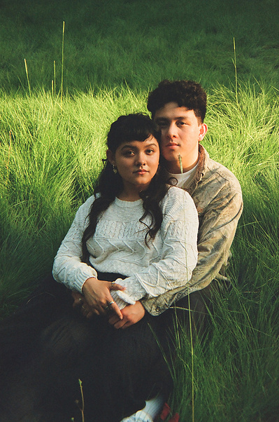 35mm film photo of two young lovebirds posing in the golden hour sun in a lush, grassy field in Irvine, CA. Natural light, organic, romantic, dreamy wedding, engagement, elopement, photography by Aly Rose Photo. Photographer in Southern California. 