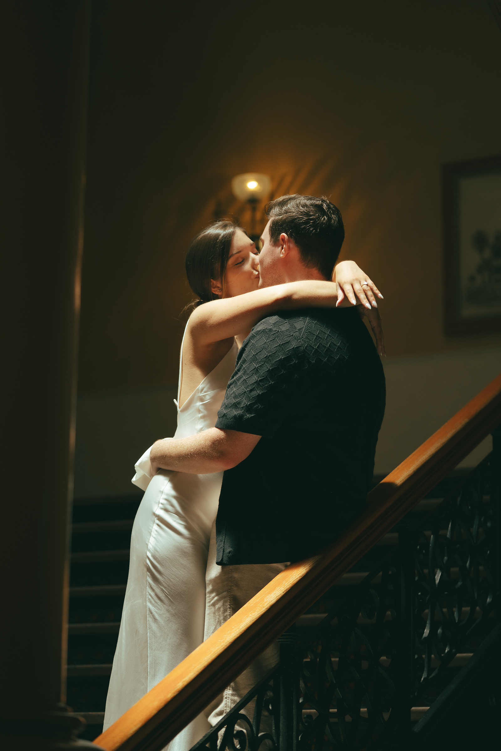 Bride and groom share a passionate kiss on the grand central staircase at the Old Orange County Courthouse, Santa Ana, CA. An intimate courthouse wedding in Southern California photographed by wedding and elopement photographer Aly Rose Photo.