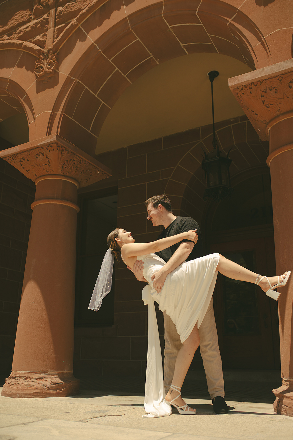 Bride and groom dip into a kiss on the front stairs at their courthouse wedding ceremony, Old Orange County Courthouse, Santa Ana, CA, Aly Rose Photo, natural light engagement, elopement, wedding, portrait, lifestyle photographer SoCal
