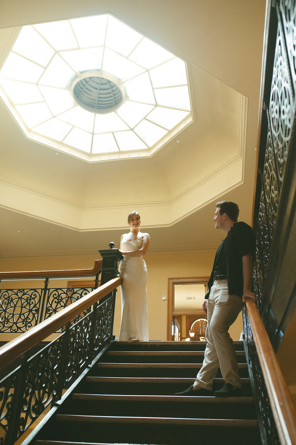 Bride and groom take portraits on the grand central staircase at their courthouse wedding ceremony, Old Orange County Courthouse, Santa Ana, CA, Aly Rose Photo, natural light engagement, elopement, wedding, portrait, lifestyle photographer SoCal