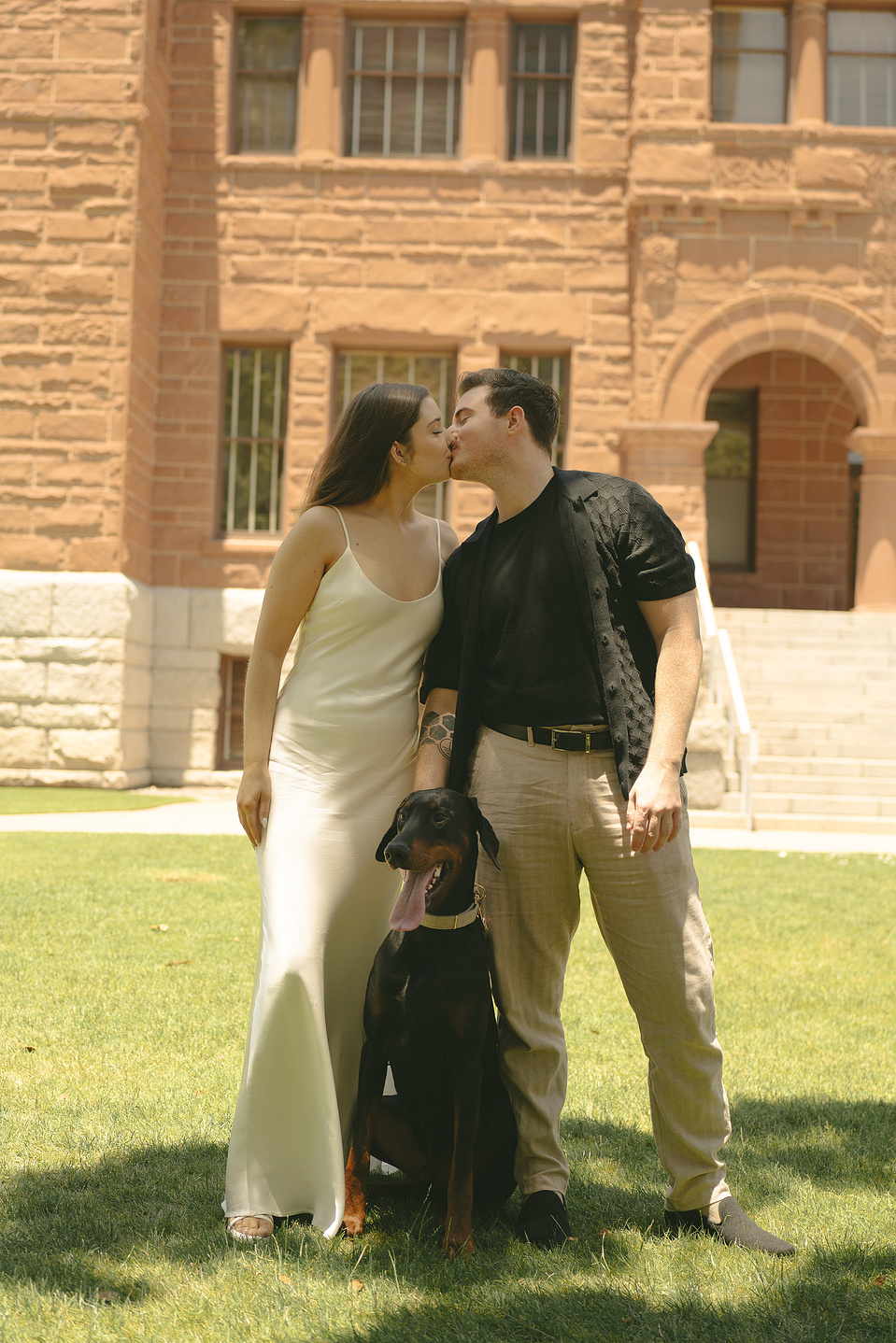Bride and groom take family portraits with their dog on the front lawn at their courthouse wedding ceremony, Old Orange County Courthouse, Santa Ana, CA, Aly Rose Photo, natural light engagement, elopement, wedding, portrait, lifestyle photographer SoCal