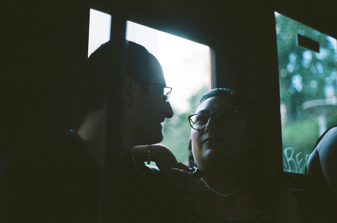 A dreamy, cinematic, 35mm film photo of bride and groom to be from their city engagement shoot in Downtown Los Angeles, CA, on the Angels Flight Railway. Photo by Southern California wedding and elopement photographer Aly Rose Photo