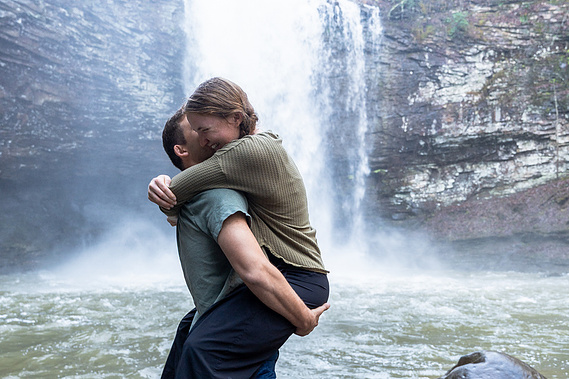 Engagement photos at Cloudland Canyon waterfall featuring romantic dancing poses and natural rock formations.