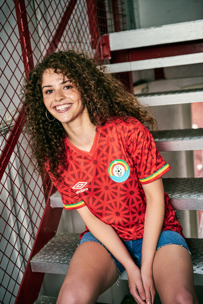 girl-smiling-stairs-Umbro-Ethiopia-shirt-shot-by-matthew-stansfield