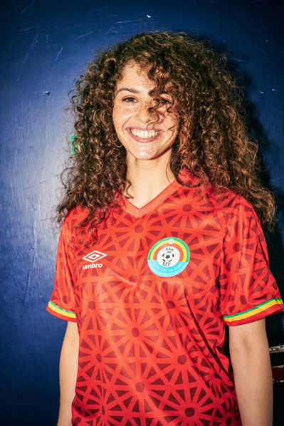 girl-curly-hair-smiling-Umbro-Ethiopia-shirt-shot-by-matthew-stansfield