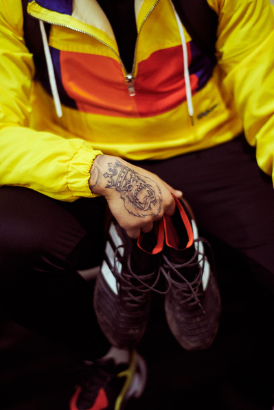 detail-guy-holding-football-boots-shot-by-matthew-stansfield