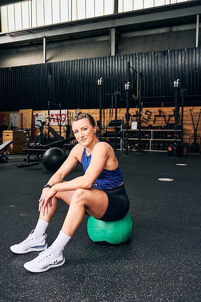 girl-athlete-resting-sitting-medicine-ball-shot-by-matthew-stansfield