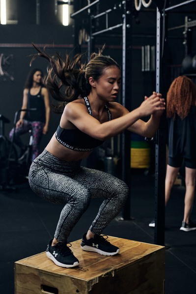 portrait of athlete in gym training jumping on bench for fitness shot for under armour photography by matthew stansfield