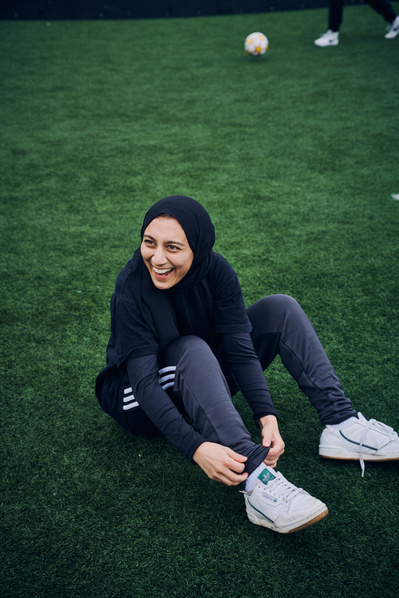 muslim-girl-footballer-hijab-tying-laces-shot-by-matthew-stansfield