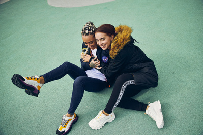 girls-hugging-sitting-basketball-court-laughing-shot-by-matthew-stansfield