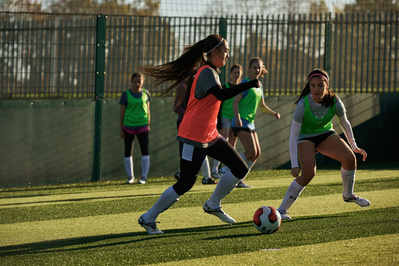 under-armour-girl-dribble-ball-football-pitch-photo-by-matthew-stansfield