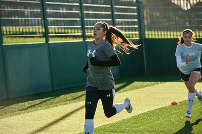 under-armour-girl-running-football-pitch-photo-by-matthew-stansfield