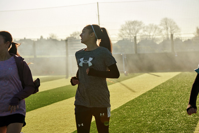 under-armour-girl-jogging-football-pitch-photo-by-matthew-stansfield
