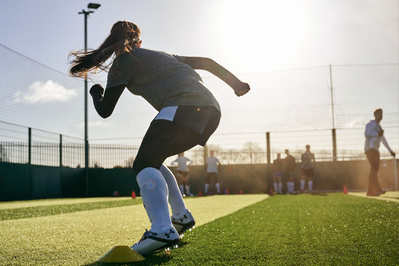 under-armour-running-girl-football-pitch-photo-by-matthew-stansfield