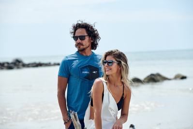 couple-smiling-sunglasses-beach-shot-by-matthew-stansfield