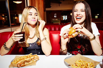 girls-fun-eating-fast-food-burger-hotdog-diner-shot-by-matthew-stansfield