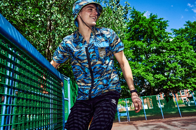 guy-jumping-smiling-park-bucket-hat-shot-by-matthew-stansfield
