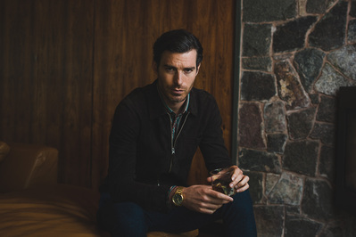 man-relaxing-drinking-whisky-shot-by-matthew-stansfield