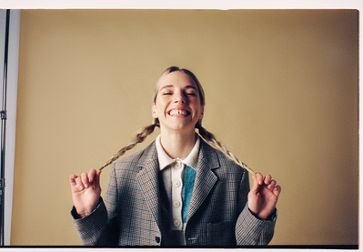 portrait-girl-sitting-laughing-plaits-film-studio-photography-by-matthew-stansfield