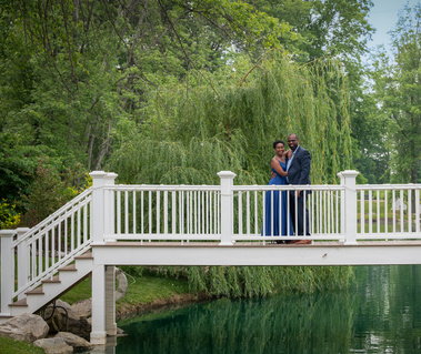 bride and groom on bridge at swan lake wedding venue.