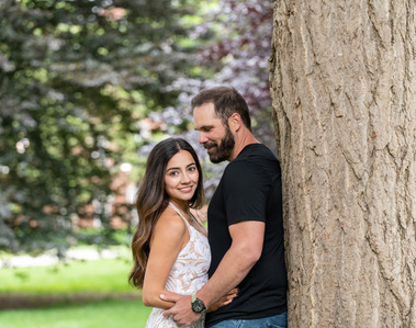 Wedding Photographer-Uniquely Created Photography. Bride and groom after the wedding. Man and woman leaning against a tree