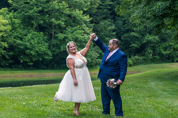 bride and groom dancing outside.