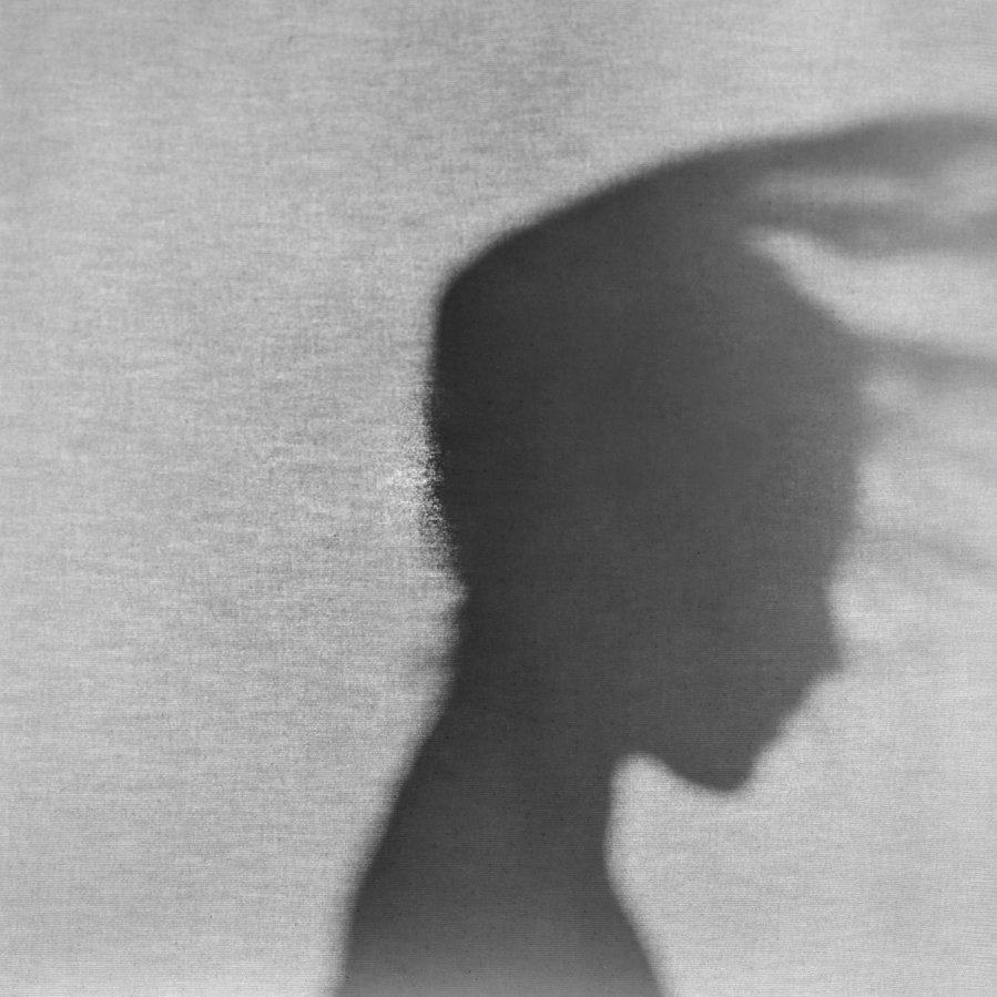 Black and white silhouette profile of a girl with her hair blowing