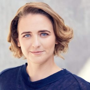 Professional actor headshot of a woman with a slight smile.