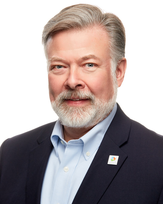 Professional corporate headshot of a mature German on a white background.