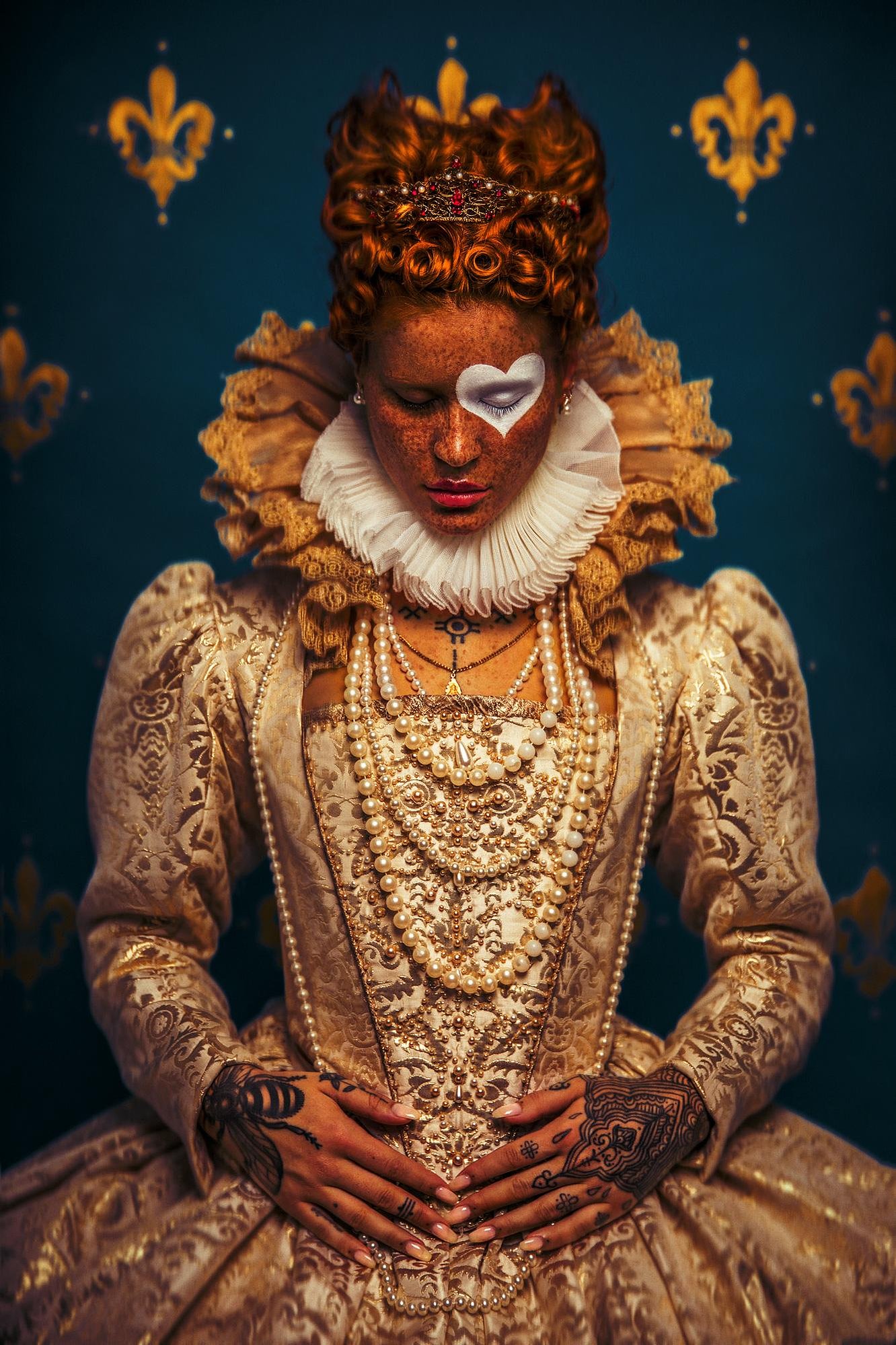 A redheaded woman dressed elegantly as the Queen of Hearts
