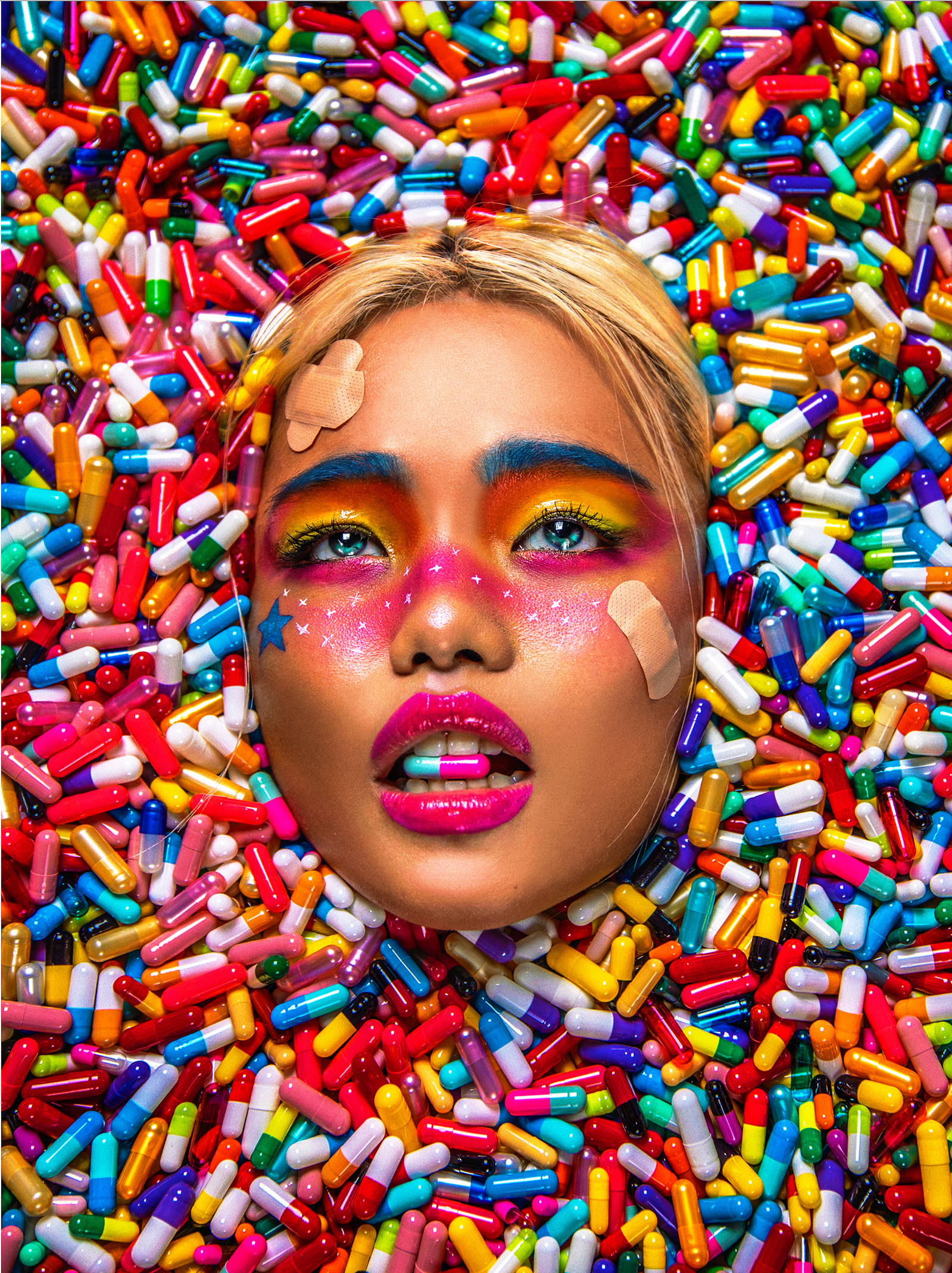 A women's face sinks into a sea of colorful prescription pills.