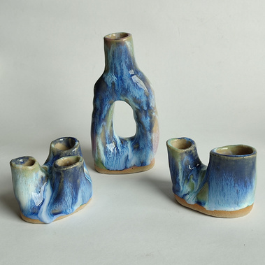 three small blue handmade ceramic vases 