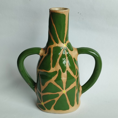 one handmade ceramic vase with two handles and green flowers painted on it.