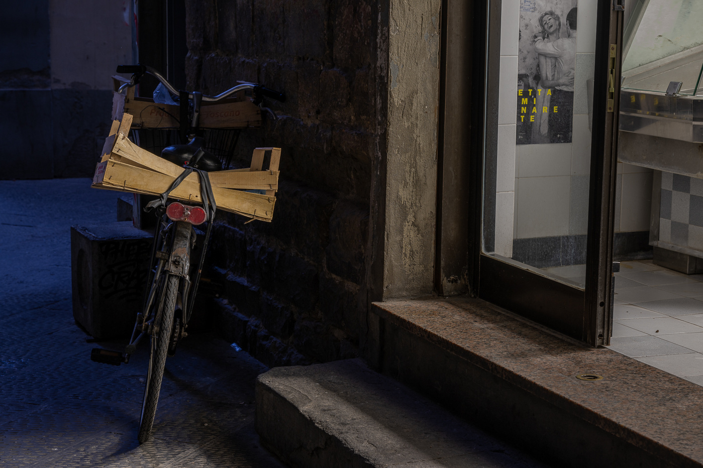 Bicycle in a dimly lit doorway in Florence Italy