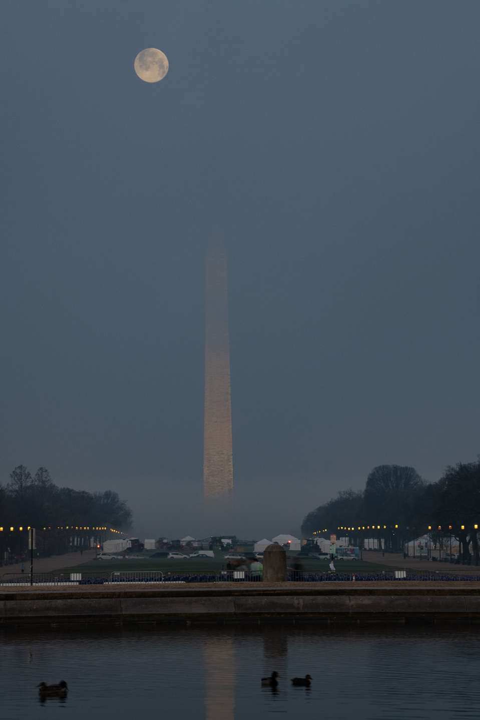 Full moon over a foggy Washington Monument with Reflecting Pool