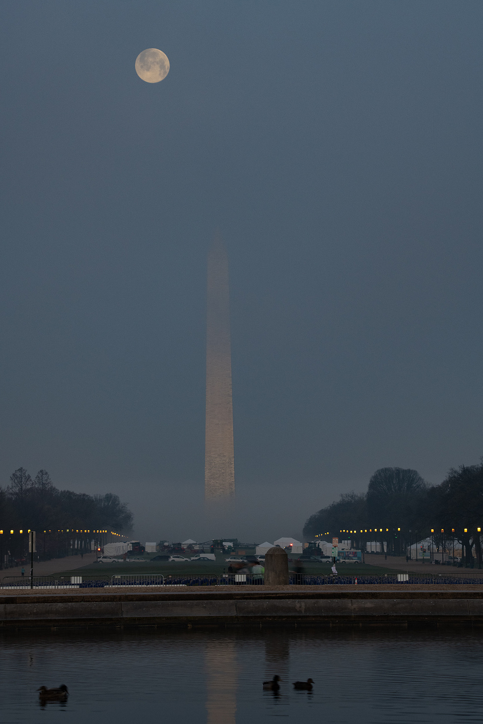 Full moon over a foggy Washington Monument with Reflecting Pool