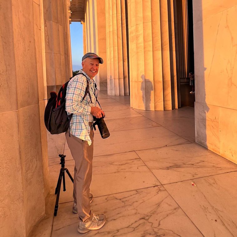 Patrick Malone photographer at the Lincoln Memorial with camera and tripod