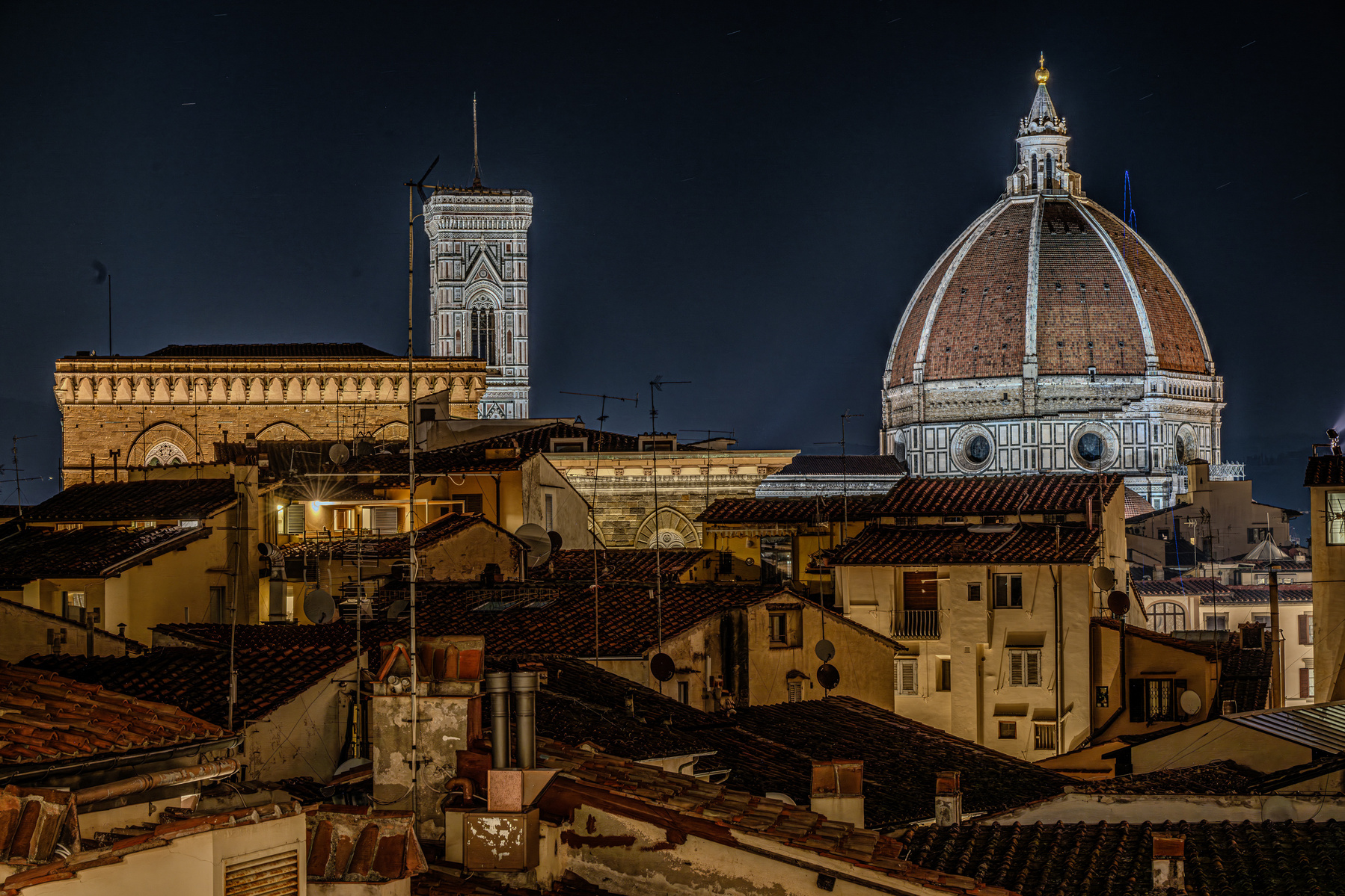 Night view of Santa Maria del Fiore cathedral duomo in Florence Italy, with dome on the right