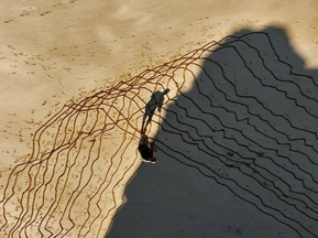 Tidal drawing in wet sand, Cornwall. Walking lines within a single tidal cycle cast long shadow; temporary sculptural work shaped by tide and duration.