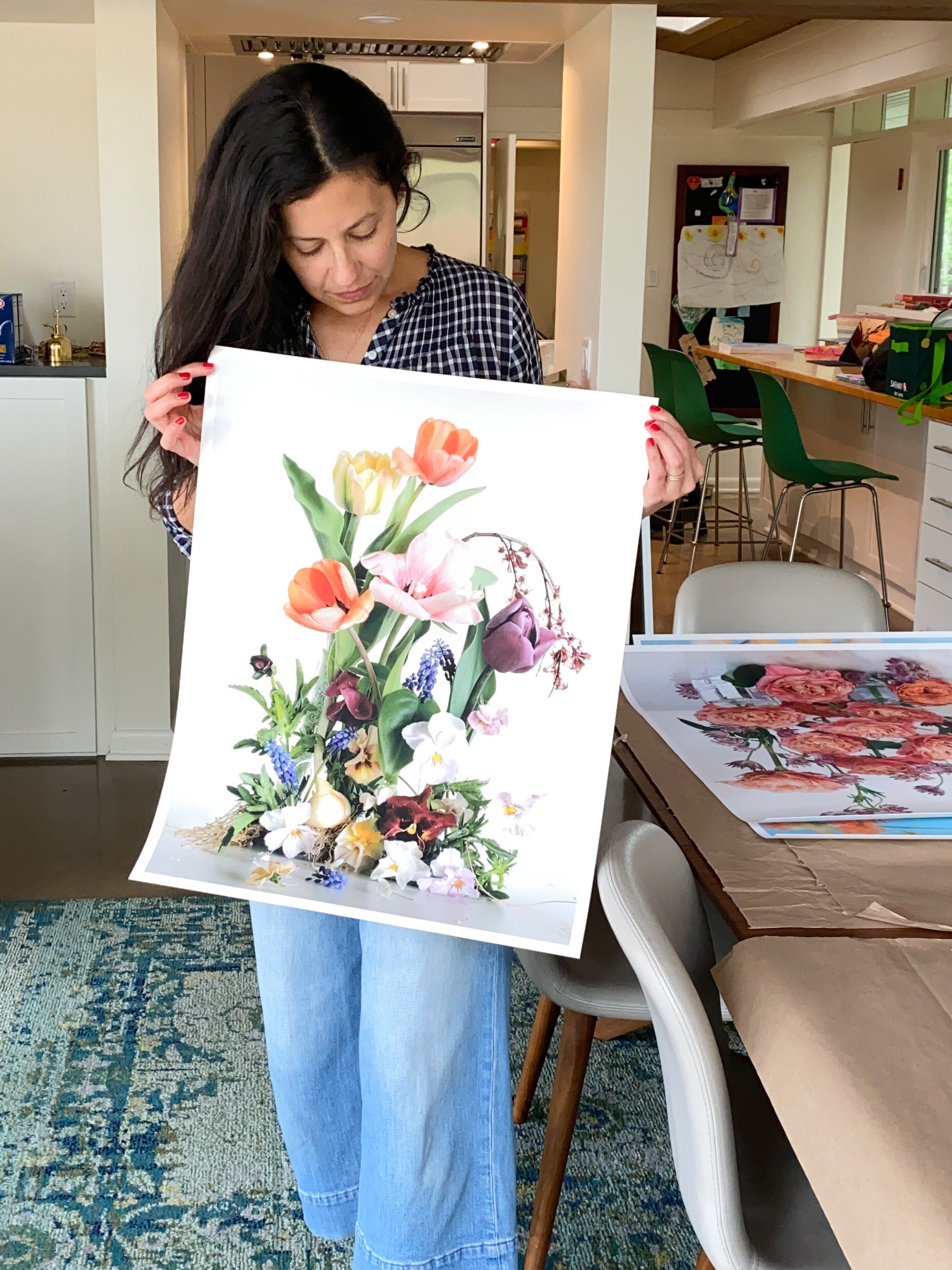 Artist holding up fine art print. 